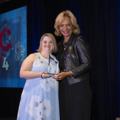 Onondaga Community College graduate Kayla McKeon '22 receives the Outstanding Alumni Award from the Ava Parker, Chair of the American Association of Community College's during its annual gathering earlier this month in Louisville.