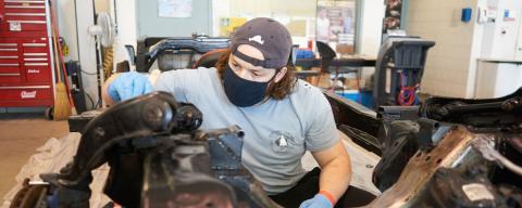 Student working on a vehicle part